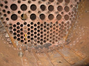 Rear tube sheet looking from inside boiler towards firebox.  Many more to go, but progress is being made 